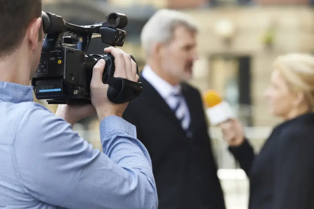 Cameraman Recording Female Journalist 